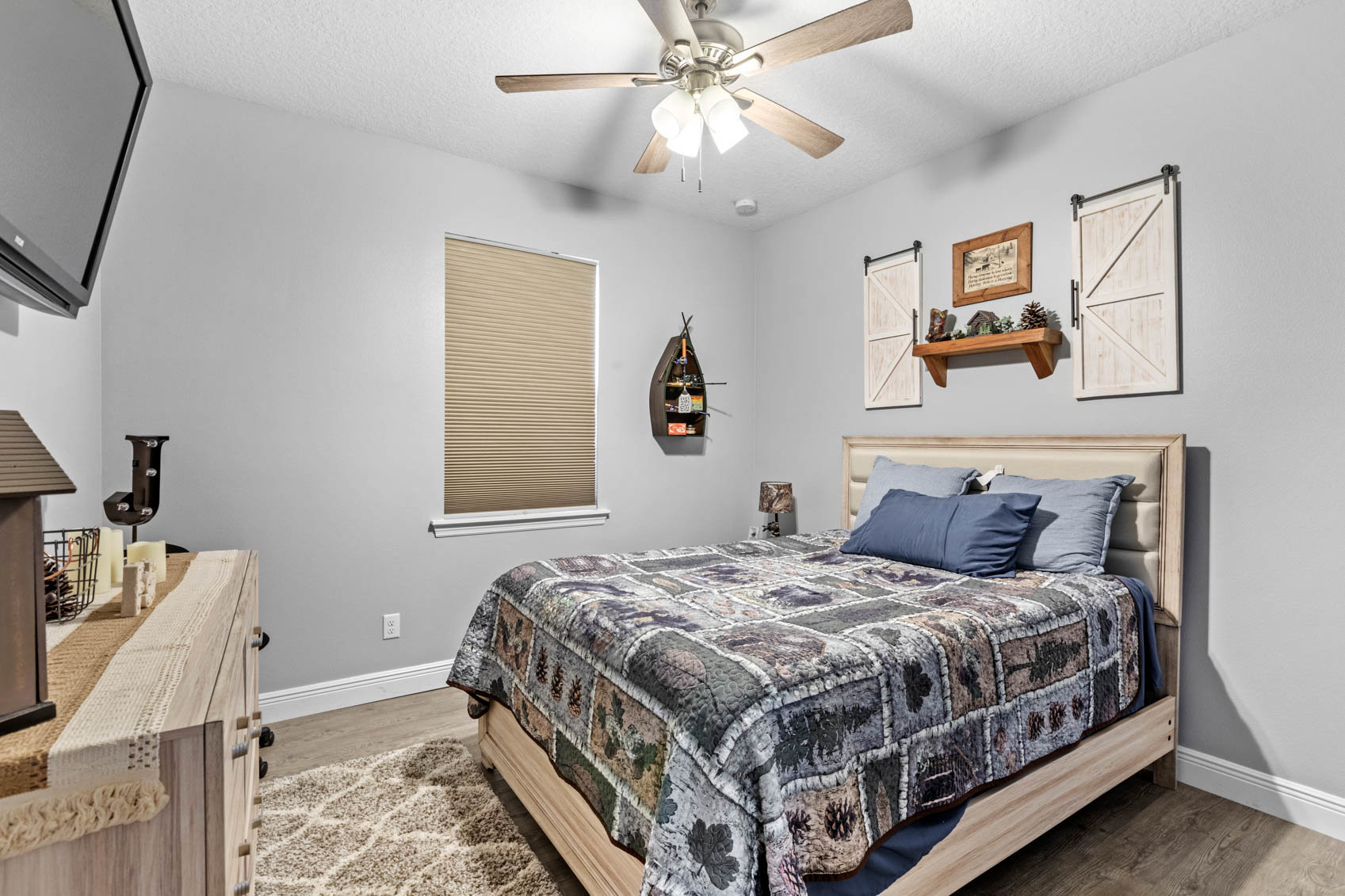 bedroom with blue and white comforter on bed